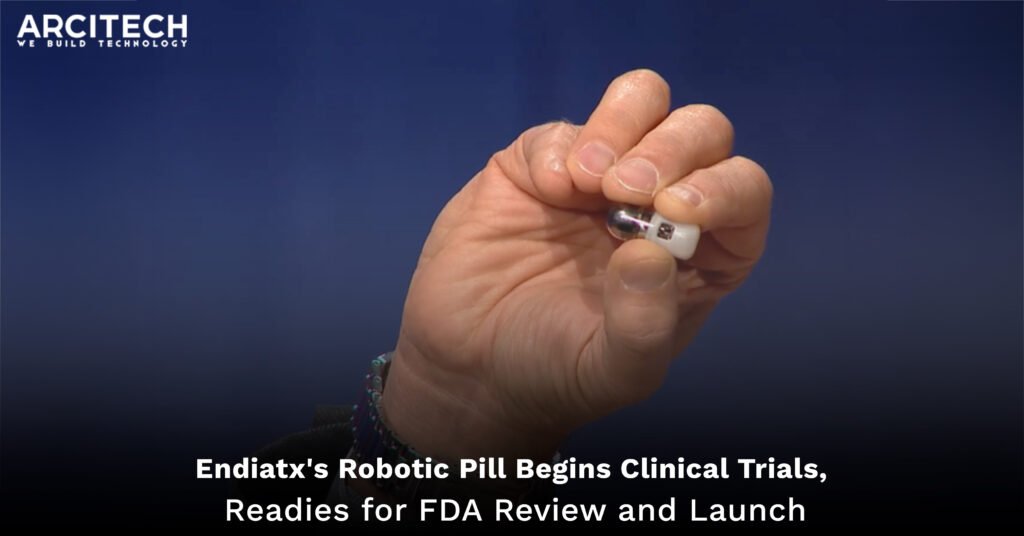 A close-up of a hand holding Endiatx's PillBot, an ingestible robotic capsule equipped with cameras and sensors, designed for gastrointestinal examinations. The background is a solid blue, highlighting the compact and innovative design of the PillBot. The image represents the beginning of clinical trials and preparations for FDA review and commercial launch.